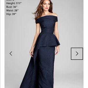 Teri Jon for Rickie Freeman .  Navy blue jacquard gown with peplum overlay.